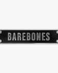 Enamel pin of a black rectangular sign with 'BAREBONES' text on a white background