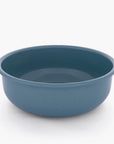 A smoky blue rolled enamel bowl on a white background