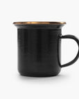 One black 5 oz enamel espresso cup with copper plated rim on a white background.