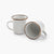 Two 5 oz speckled eggshell enamel espresso cups with copper plated rims on a white background.