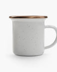 5 oz speckled eggshell enamel espresso cup with copper plated rim on a white background.