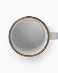 5 oz speckled eggshell enamel espresso cup with copper plated rim on viewed from above on a white background.
