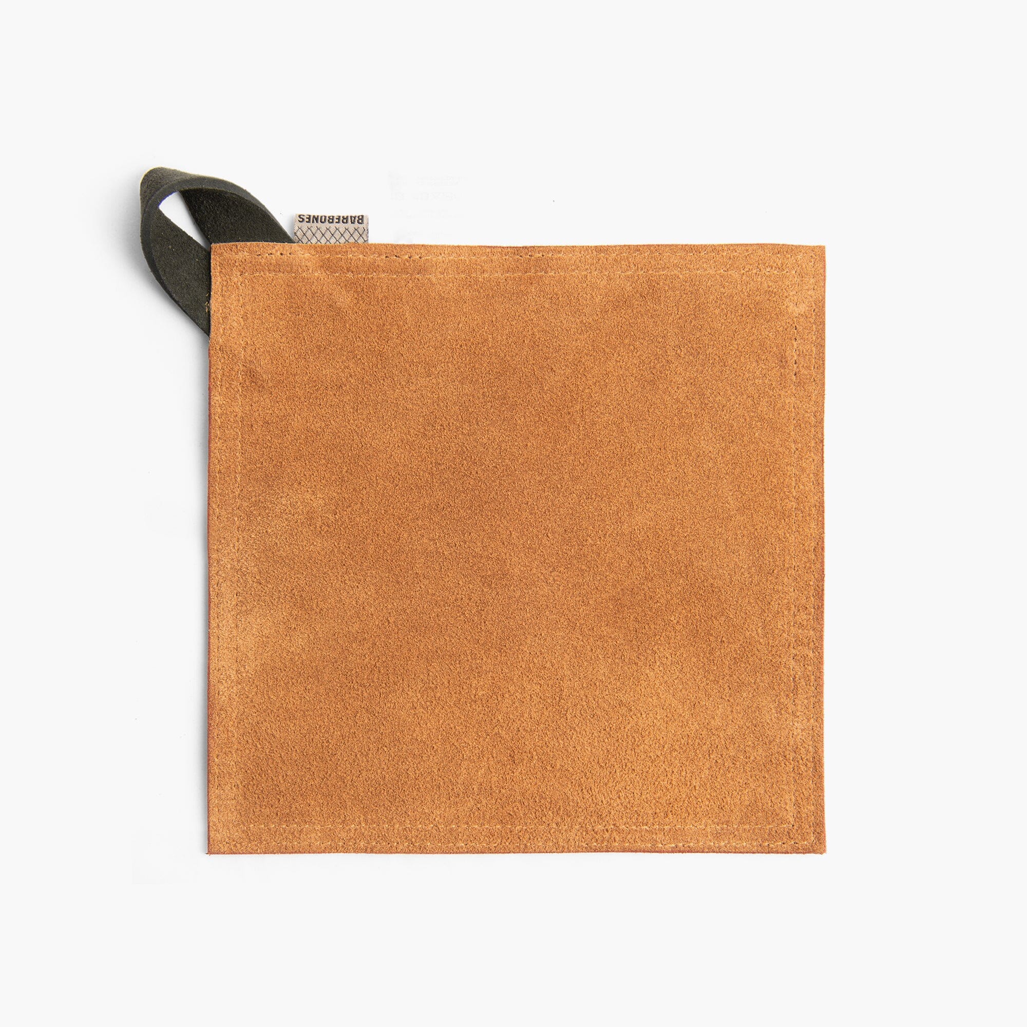 Tan suede leather hot pad with a black hanging strap on a white background